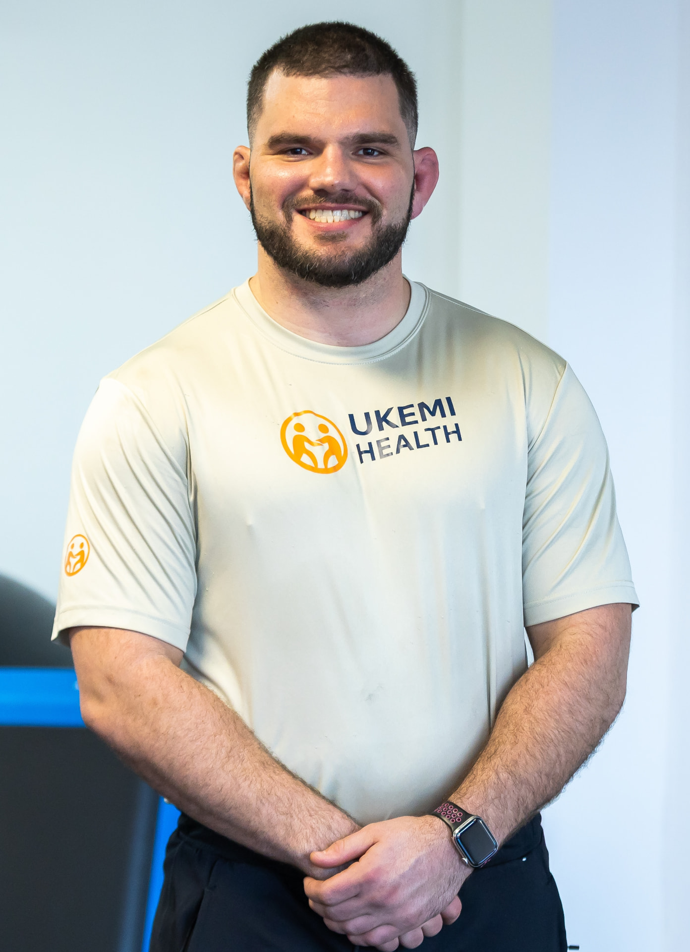 Bryan DePhillip, founder of Ukemi Health Partners, smiling in an Ukemi Health shirt